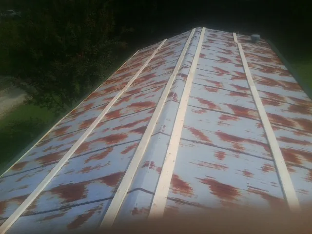 Rusted metal roof panels with new wood purlins before replacement — Storm Damage Roof Repair in Canoga Park by Roofing Brothers